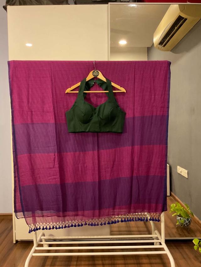Striped saree with a bottle-green halter-neck blouse