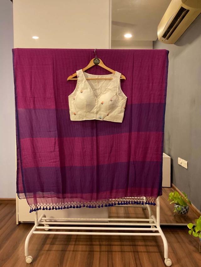 Striped saree with an ivory sleeveless blouse with tiny floral embroidery